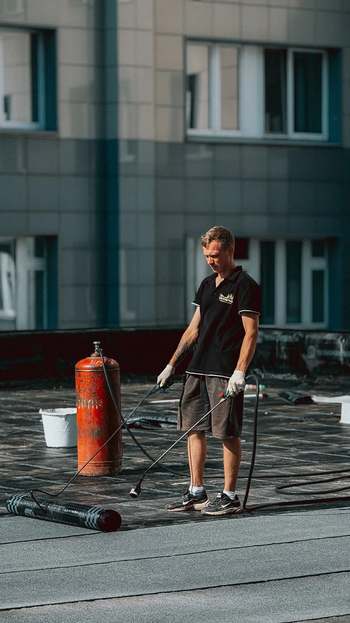 Mise en œuvre d'une membrane d'étanchéité sur un toit plat, rappel qu'une toiture-terrasse impose de protéger le complexe sous les plots